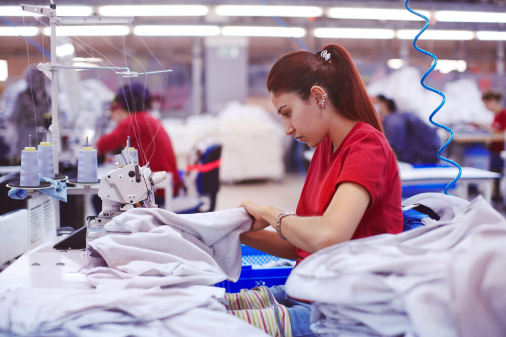 Photo of a young female tailor working in a textile factory